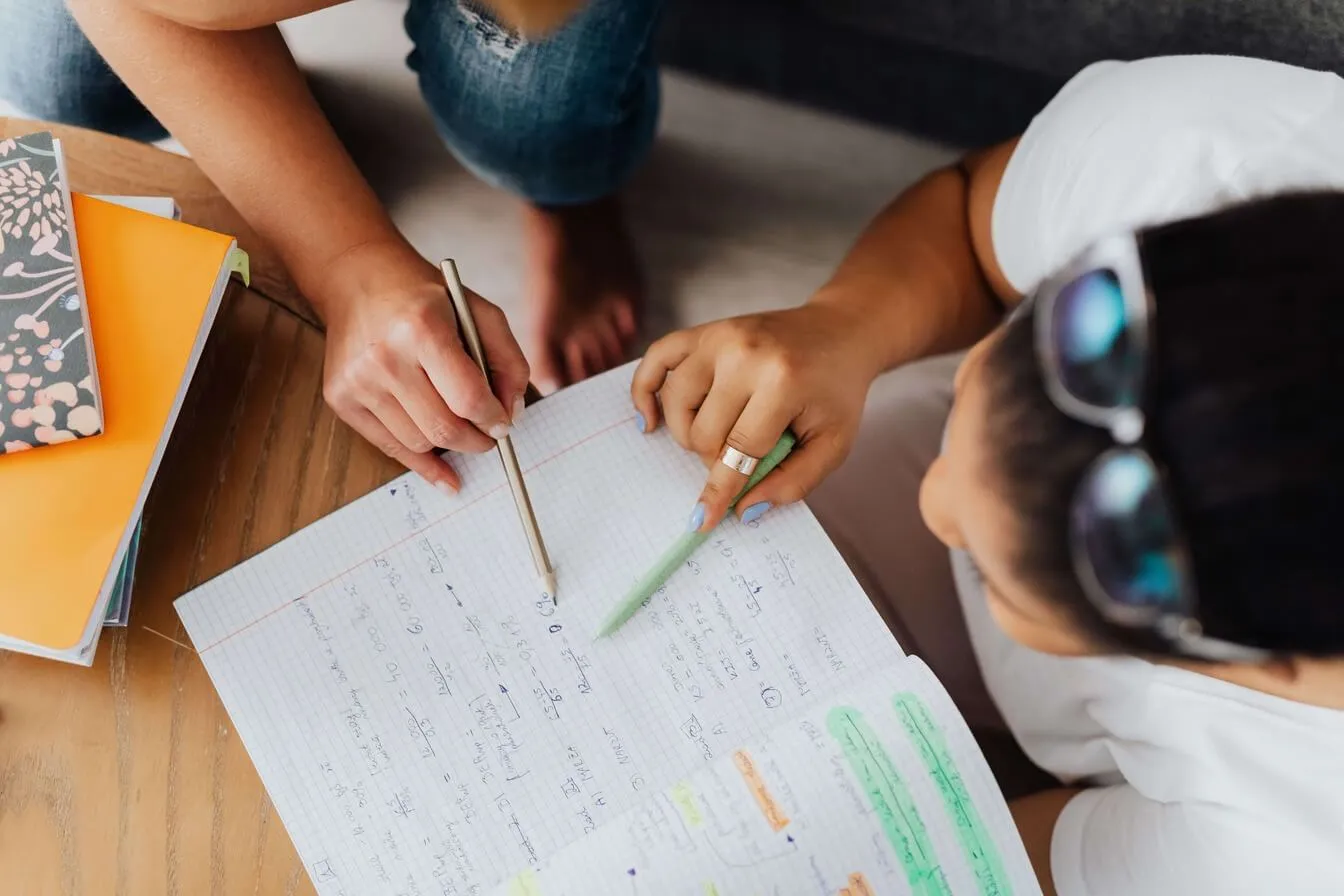 Student working through exam preparation notes